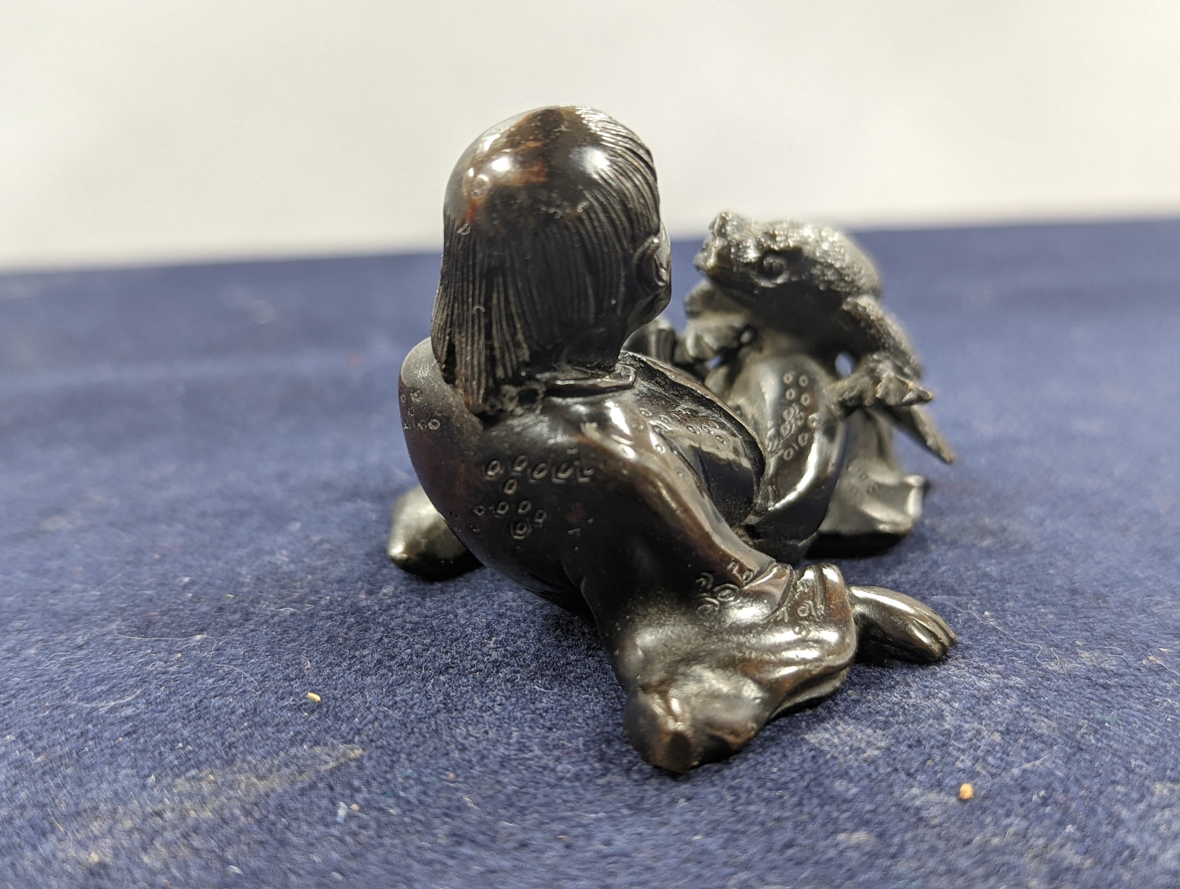 A Chinese bronze group of Liu Hai and a toad, wood stand and a bronze figure of a dog, 9cm